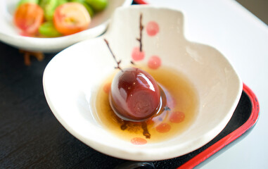 Single preserved Quail eggs egg served in small white bowl