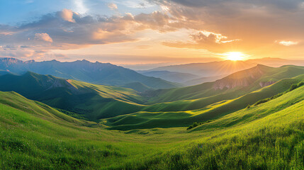 A panoramic view of rolling green mountains illuminated by a golden sunset.