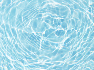 Blue water with ripples on the surface. Defocus blurred transparent blue colored clear calm water surface texture with splashes and bubbles. Water waves with shining pattern texture background.
