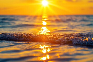 A close-up shot of golden sun rays reflecting off the calm ocean waves during sunset, representing peace and good fortune.