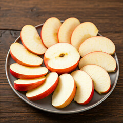 red apple on a plate. close up of slice of apple in a plate. tasty delicious healthy food slice of apple in plate.