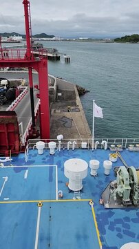 Ship with Japan flag at berths ready to depart from the Shin Moji Port Terminal in Fukuoka, Japan