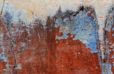 Old grunge wall with blue and red paint. Abstract background for design.