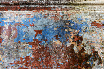 Old grunge wall with blue and red paint. Abstract background for design.