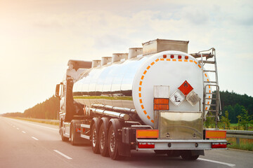 Tanker truck carrying flammable LNG and crude oil materials on highway