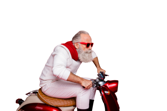 Elderly santa man moving fast to party by vintage moped wear white jumper and trousers isolated red background