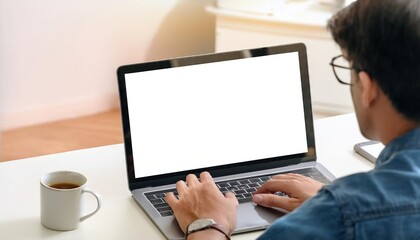 young man using computer laptop in front of an blank white computer screen in home 