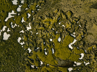 Frozen lava fields with snow in daytime