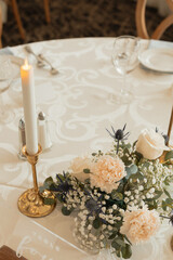 wedding table decor with pillar candles and florals
