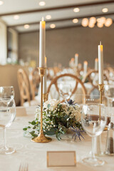 brass candle sticks with white wedding candles