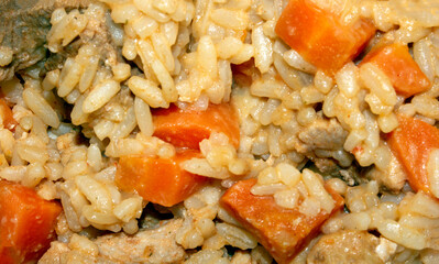 Uzbek pilaf with meat and spices.Pilaf with meat background.Rice with meat and seasonings.