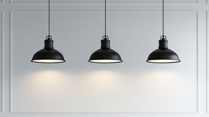 Obraz premium Three black pendant lights hanging symmetrically in front of a plain white wall, perfect for a clean and modern lighting mockup. 3D rendering.