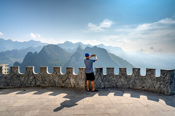 Ha Giang Province, Vietnam - September 15, 2024: Tourists standing on the top of the mountain stop...