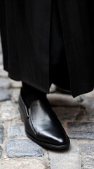 Black Leather Shoe on Cobblestone