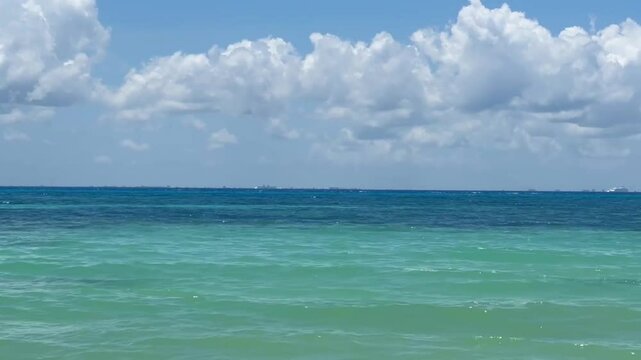 Handheld wide panning shot across the Cozumel Channel from Playa del Carmen in Quintana Roo, Mexico. 4K