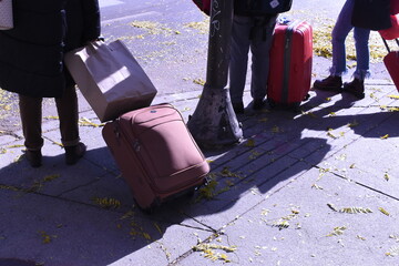 Tourists with Suitcases Waiting to Cross the Street