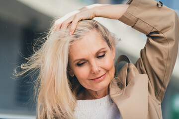 Portrait of senior dreamy female resting walking strolling enjoy weekend touch hair gorgeous wear...