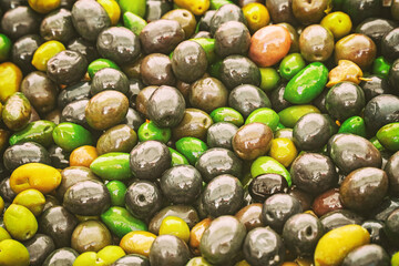 Background of tasty spicy olives in Volterra market, Tuscany, Italy