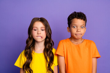 Photo of charming two little children nervous scared amazed wear trendy orange yellow outfit isolated on violet color background