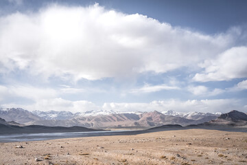 Panoramic landscape of textured Tien Shan mountains in Pamir in Tajikistan, panoramic landscape of a mountain range with snow and glaciers in summer