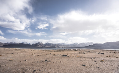 Panoramic landscape of textured Tien Shan mountains in Pamir in Tajikistan, panoramic landscape of a mountain range with snow and glaciers in summer