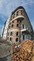 Obraz premium Exterior View of a Partially Constructed Multi-Story Building with Brick and Plaster Walls
