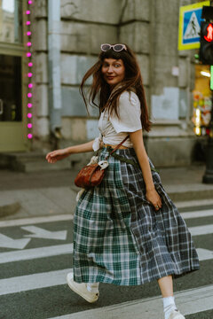 Smiling young woman in the city.
