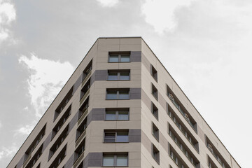 Underside view of triangular top of building over blue sky