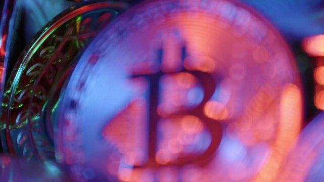 racking focus shot of multiple golden cryptocurrency coins including bitcoin