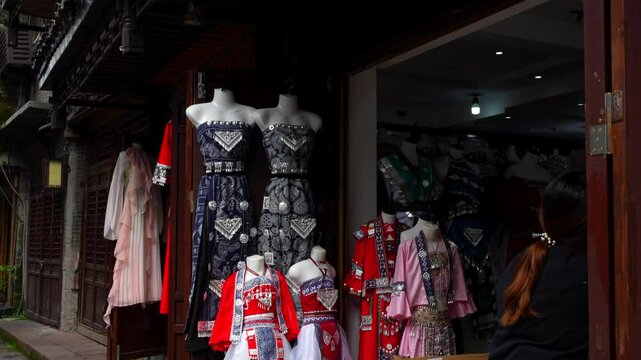 Chinese store with several traditional dresses from different ethnicities on display at Phoenix Ancient Town