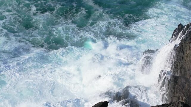 Foamy Waves Hit The Rocky Coast On A Bright Sunny Day At Seixo Branco Beach Near Oleiros, A Coruna, Galicia, Spain. Slow Motion Shot