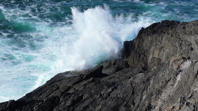 Waves Crashing Against Rocks And Foamy Sea Surface At Seixo Branco Near Oleiros, A Coruna Province, Galicia Spain. Slow Motion