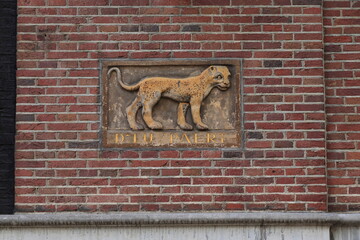 Old Sculpted Tablet on a Brick Wall Depicting a Leopard in Amsterdam, Netherlands