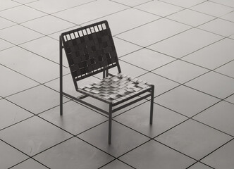 A modern black chair with a woven seat sits on a tiled floor.