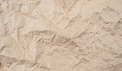 Recycled brown creased paper background from a paper packing. Crumpled brown paper texture concept