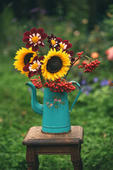 Autumn bouquet of sunflowers in vintage jug