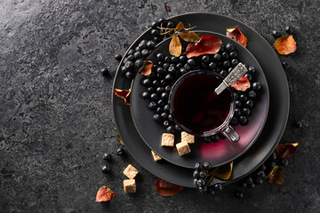 Black chokeberry juice, fresh berries, and pieces of brown sugar.