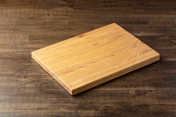 Cutting board on a wooden table.