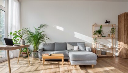 Modern scandinavian living room with design furniture, grey sofa, plants, bamboo bookstand and wooden desk. Brown wooden parquet. Nice apartment. Stylish decor. Bright and sunny side of home space.
