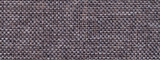 Texture dark brown and gray background from woven textile with wicker pattern, macro. Structure vintage umber fabric