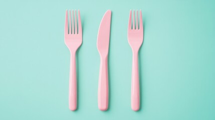 Three pink plastic utensils, a fork, a knife, and a spoon
