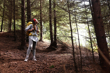 Obraz premium Young hiker with backpack enjoying time in forest