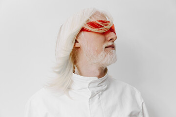 Futuristic portrait of a man with long white hair and a striking red blindfold against a minimalist white background, embodying themes of vision and perception