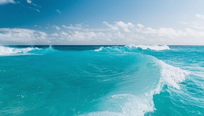 Obraz premium Wavy Clear Ocean Under Blue Sky with Clouds