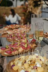 several filled champagne glasses in a festive setting, wedding, celebration, party.