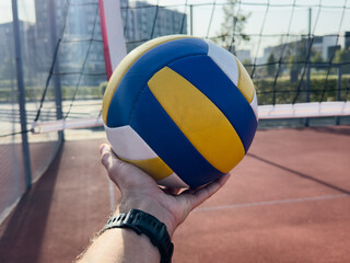 volleyball. blue with yellow color ball on the playground. volleyball cover, red. ball game