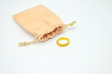 Light brown small purse or pocket with a gol ring with diamond © wira