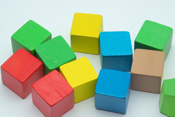 Colored cubes on white. cube color concept. a wooden board with cubes of different colors on a white . a small wooden cube with colored outlines on a white lifestyle.