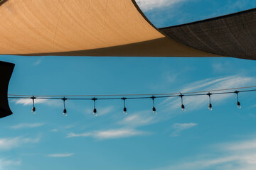 “Strings of light beneath the endless sky, where simplicity meets beauty.”