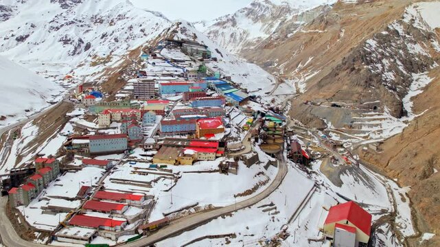 Aerial Top Down Residential Settlement, Ex Mining town of Sewell in Chile Andean Cordillera snowy Mountains